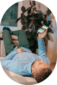Man laying down on BackHug device and holding phone